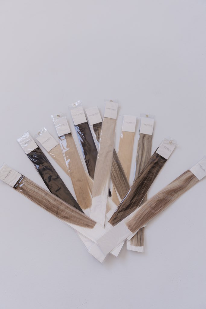 Close macro of glossy hair extension weft strands, black and white