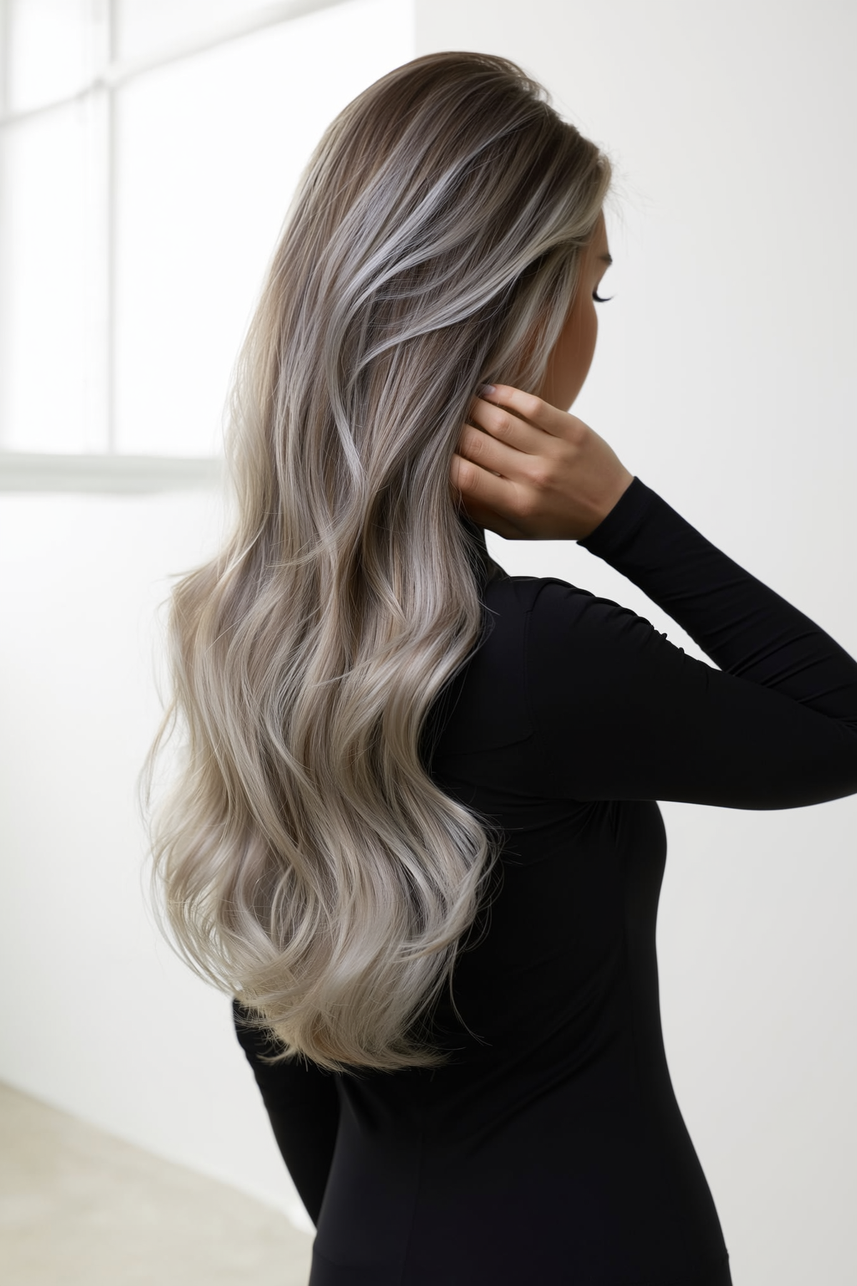 Model with long #p10/60A ash-beige blonde Lushe Hair Co. extensions, back view